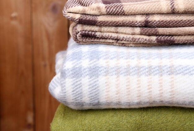 Warm plaids on rustic wooden background