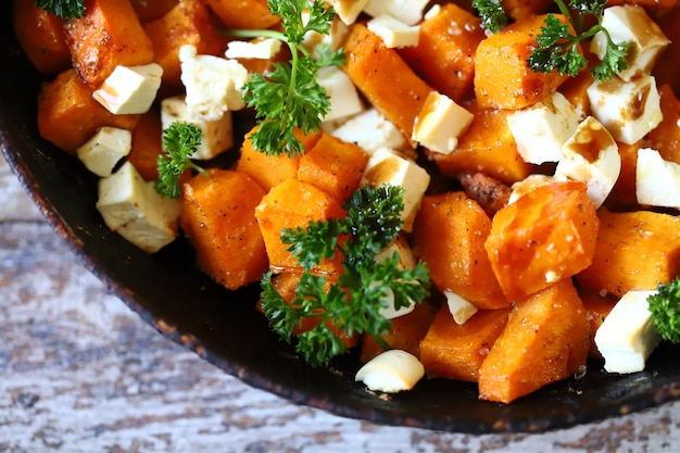 Warm pumpkin salad with feta cheese and parsley