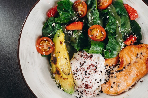 Warm salad with poached egg salmon and avocado