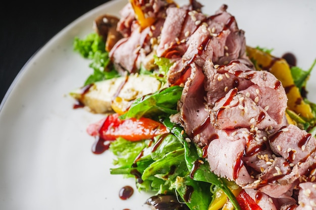 warm salad with roast beef eggplant zucchini mushrooms and pesto sauce