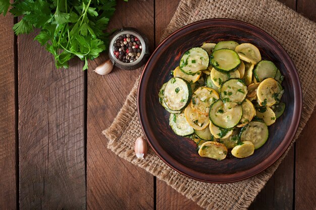 Warm salad with young zucchini with garlic and herbs.