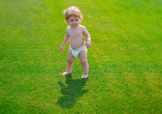 Warm spring child wearing a diaper in the park