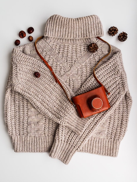 A warm wool sweater and an old camera in a case