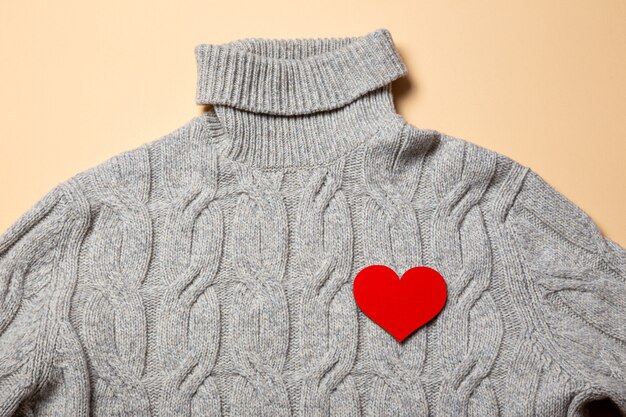 Warm wool sweater with a red heart on the chest