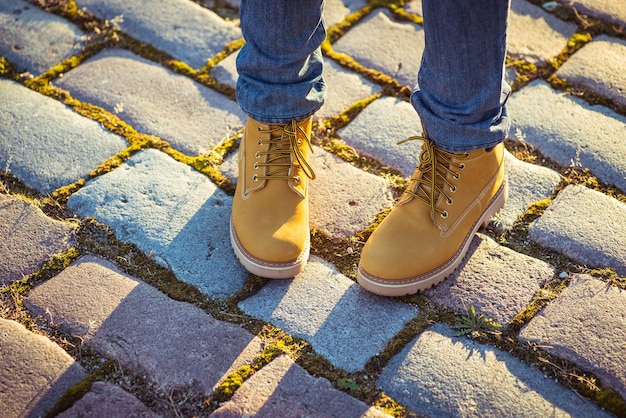 Warm yellow boots Walking in autumn leaves