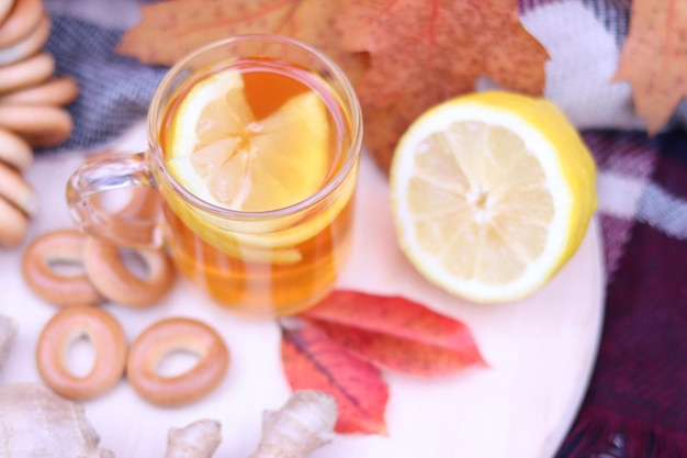Foto warme kop thee met herfstbladeren, pompoenen, gember, citroen en bagels. herfst stemming. verwarmend drankje
