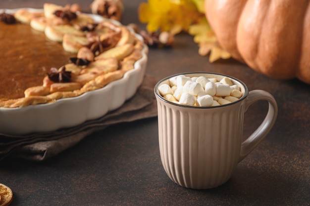 Warming coffee and homemade pumpkin pie with for autumn cozy day