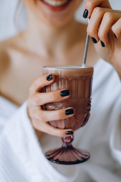 Warming cup of coffee in the hands of women