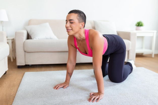 Warming Up Before Workout Smiling Sporty Black Woman Training At Home Or Fitness Club Studio Beautiful Female Stretching Legs After Exercises On Mat