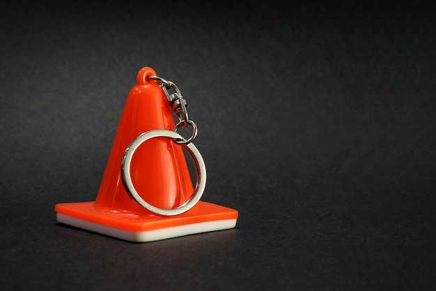 Warning of danger, traffic cone in the form of a keychain