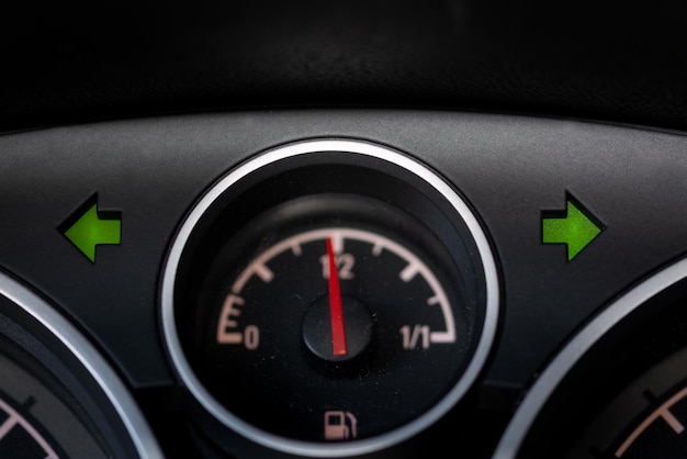 Warning light and fuel gauge on the dashboard of a car