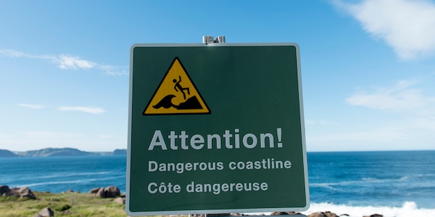 Warning sign at coast, cape spear, st. john\'s, newfoundland and\
labrador, canada