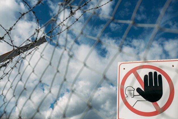 Photo warning sign on metal fence