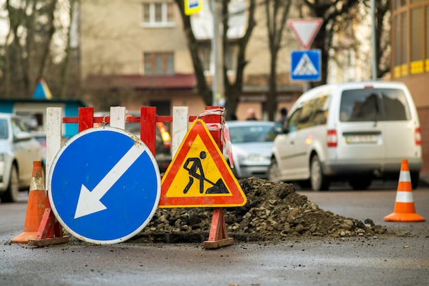 Warning street sign on road work site.