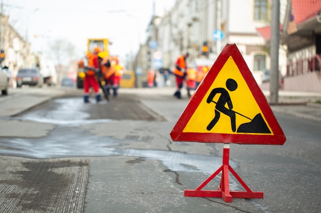 Warning street sign on road work site.