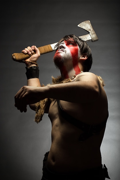 a warrior brandishing an ax up furiously