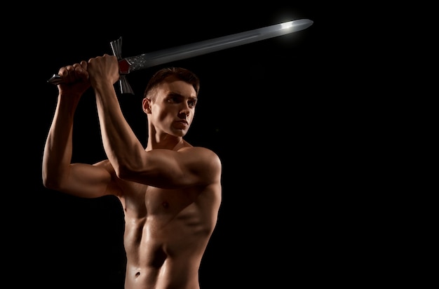 Warrior fight with sword isolated on black.