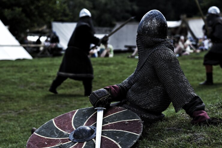 Photo warrior with sword and shield sitting on field