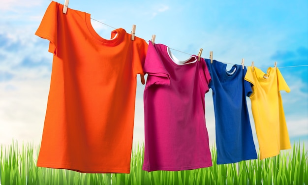 Wash clothes on a rope with clothespins on background