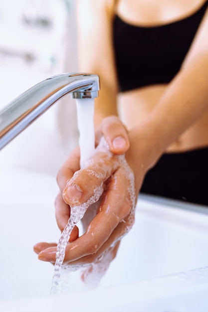 Wash hands under running water