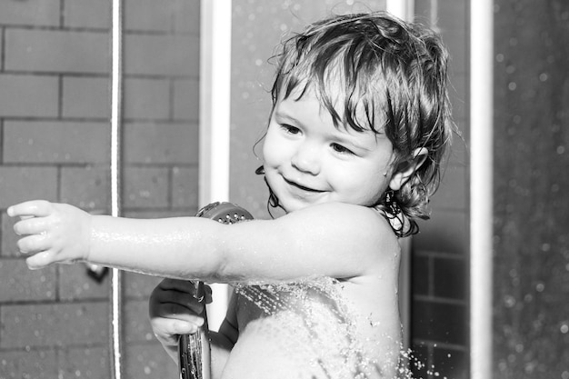 Wash infant hygiene and health care Baby face in bubble bath Happy funny baby bathed in the bath