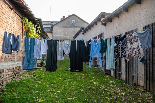 Washed laundry pegged out on a washing line in the court yard on a cloudy day