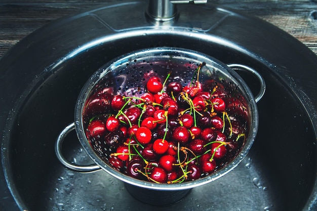 Washed ripe red cherries in a colander