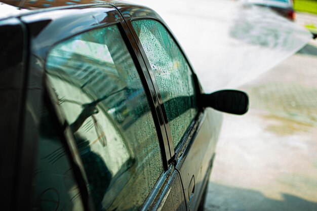 washing a car with a pressure washer