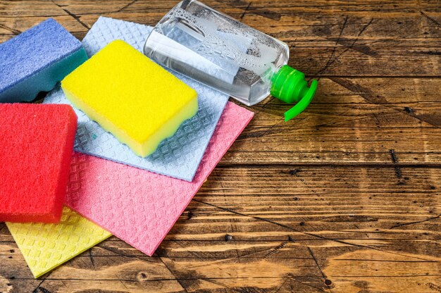 Washing and cleaning stuff, domestic supplies for spring cleaning service. wooden background. Top view. Copy space.