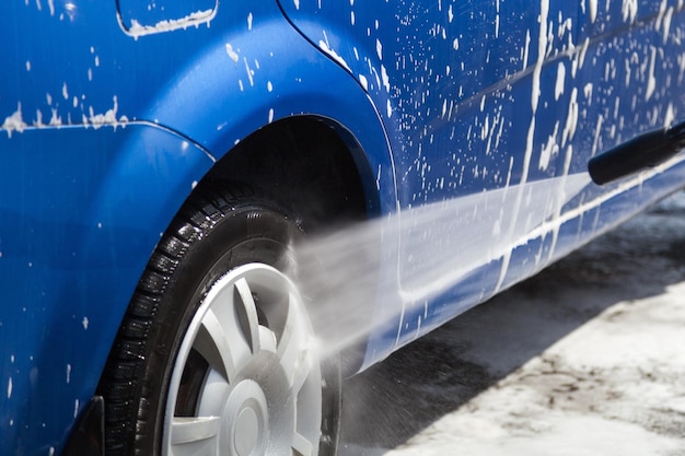 Washing dirty car wheels with high pressure.