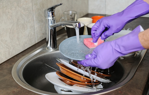 Washing dishes in the kitchen.