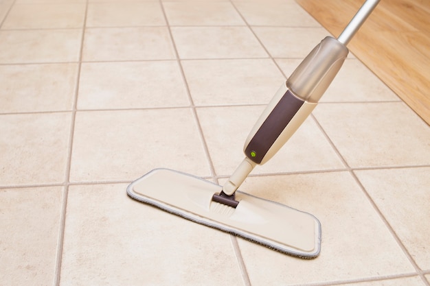 Washing the floor with a spray mop