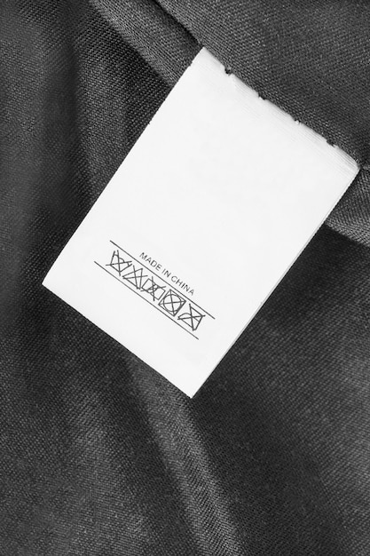 washing instructions clothes label says made in china on black fabric background