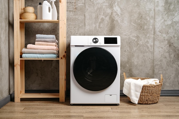 Washing machine in a gray modern laundry room