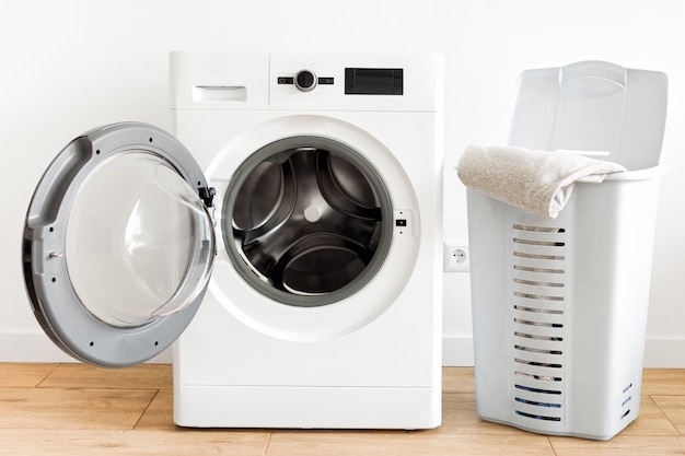 Photo washing machine with laundry basket in the home laundry room