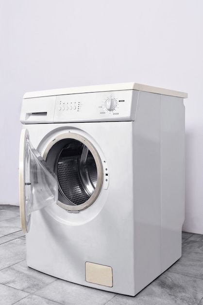 Photo washing machine with open door at home