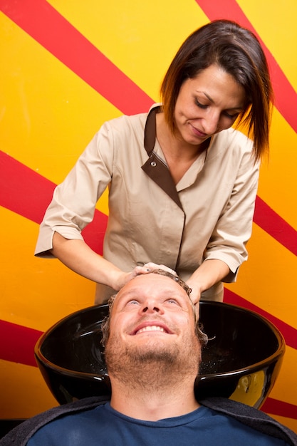 Washing man hair in beauty parlour hairdressing salon