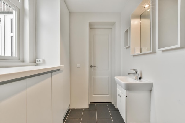 Washroom with brown tile floor and small window