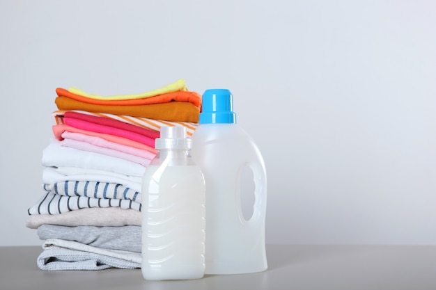 Wasmiddelflessen en kleding op tafel huishoudelijke chemicaliën