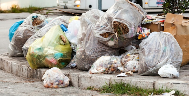 Waste bags in the street on the sidewalks