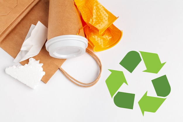 Waste recycling eco symbol with garbage disposal on table  top 