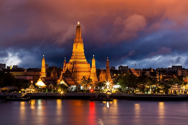 Wat Arun Buddhist temple at Chao Phraya river side in evening Bangkok Thailand