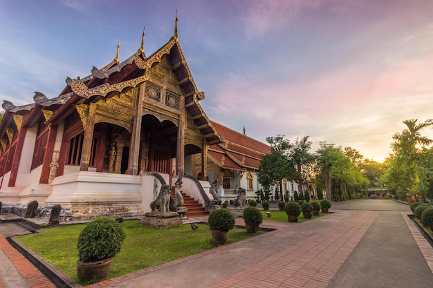 Wat Phra Singh temple pavilion at pink sunrise. Chiang Mai, Thailand.