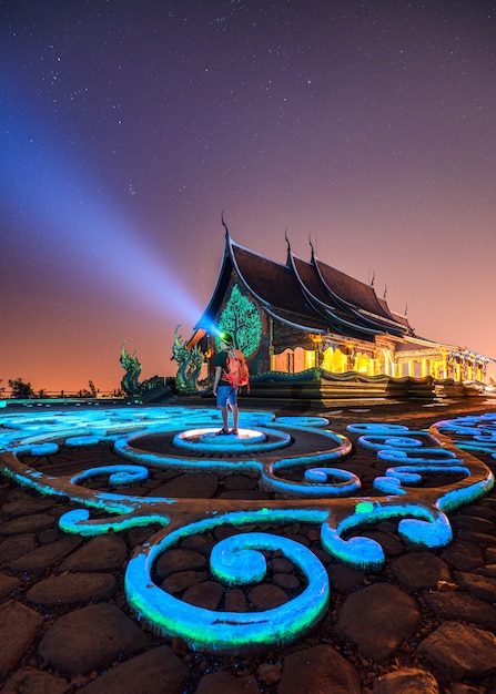 Wat Sirindhorn Wararam Temple or Wat Phu Prao with man backpacker