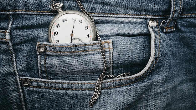 A watch in a pocket of blue jeans