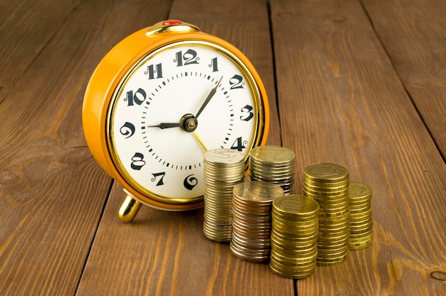 Watches and coins on a wooden table