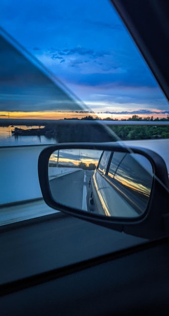 Watching the sunrise through the window of a vehicle and the light of the sunrise