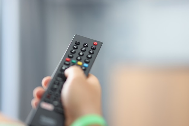 Watching tv and using the remote control concept