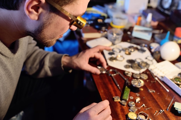 Watchmaker repairing clockwork