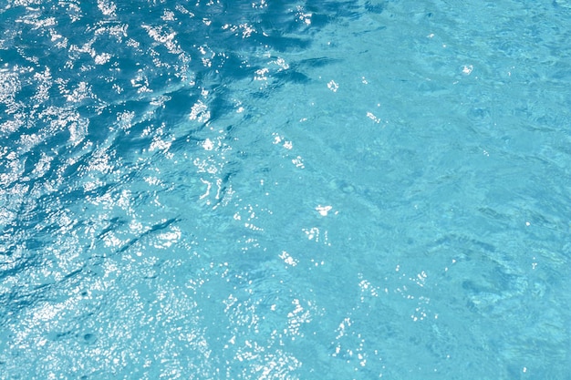 Water and air bubbles over blue background in swimming pool